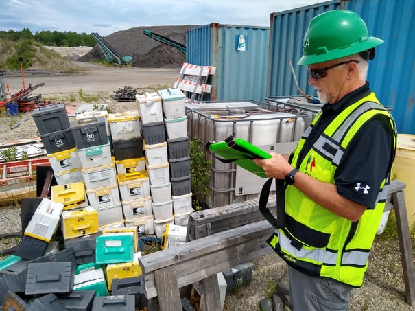 environmental consultant conducting environmental site assessment with clipboard