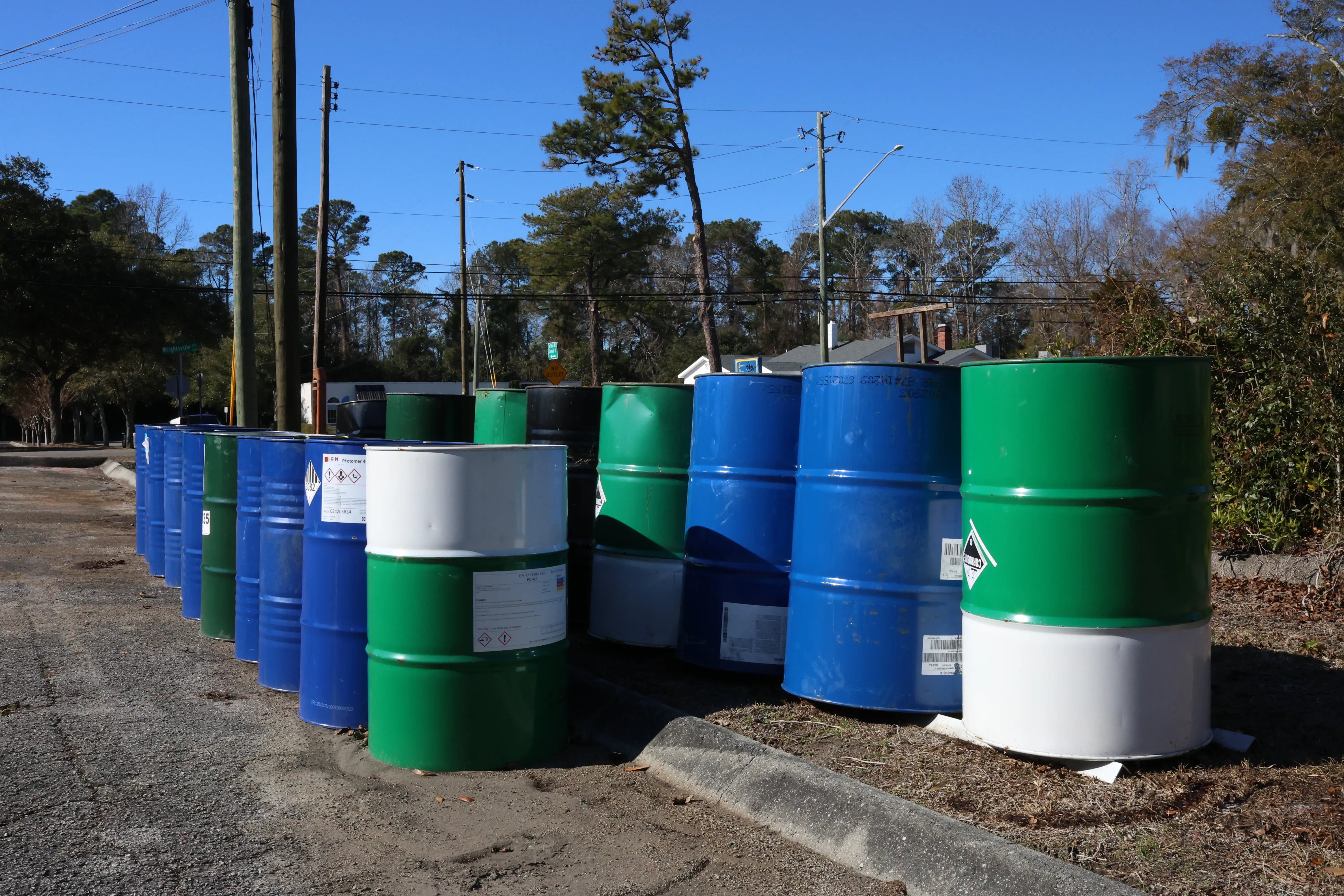 blue and green drums of chemicals