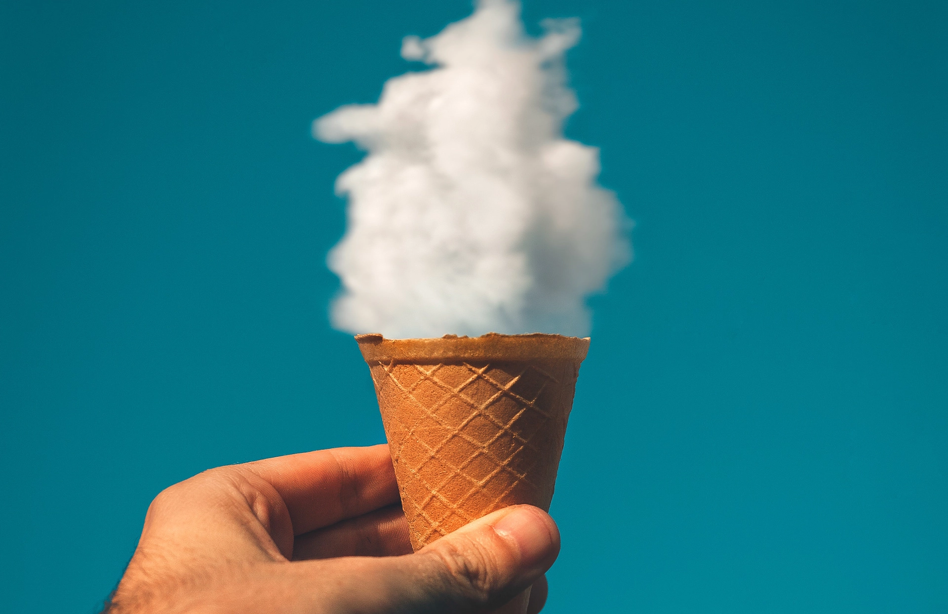 Hand Holding Ice Cream Made From Clouds