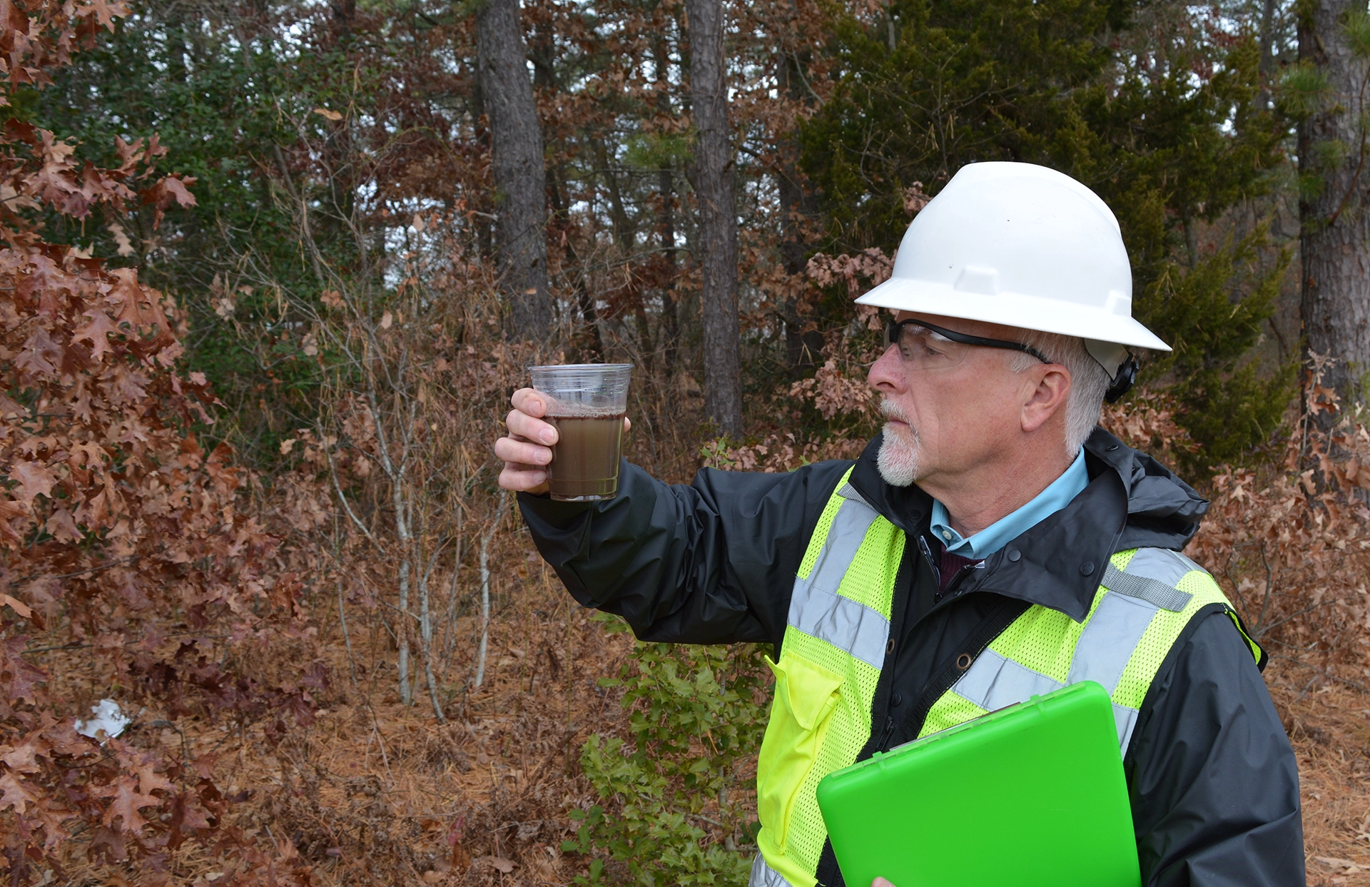 Man Inspecting Stormwater Discharge Sample